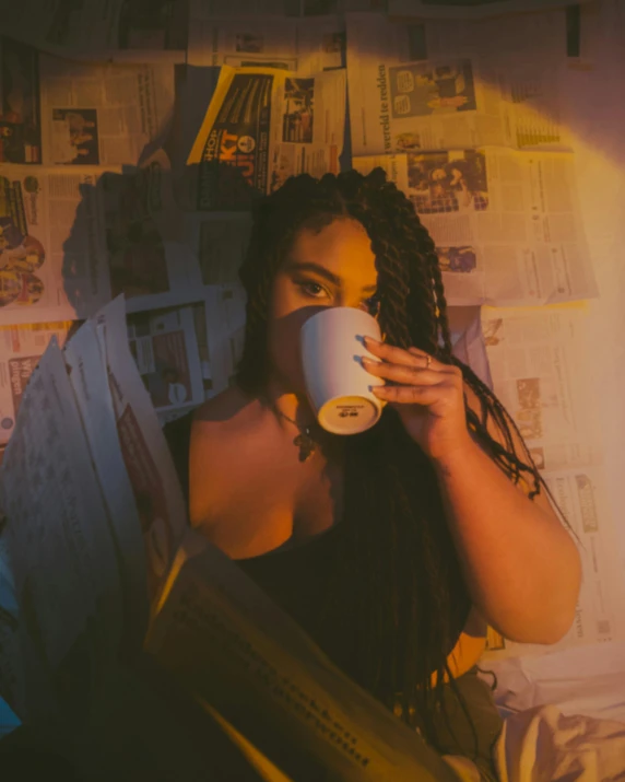 a woman drinking coffee in her bed