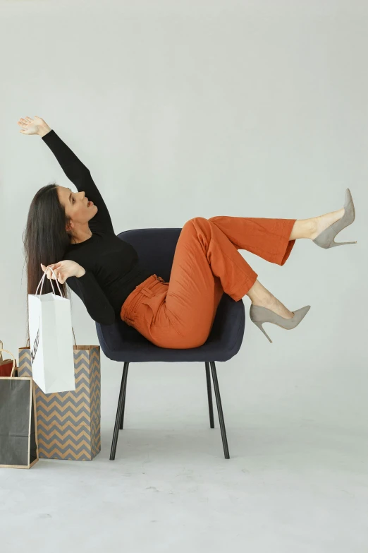 a woman sitting in an empty chair on top of a pile of gifts