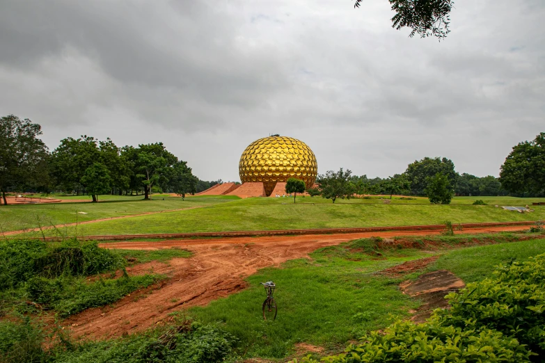 a field with an object in it, that looks like it is made out of pineapple