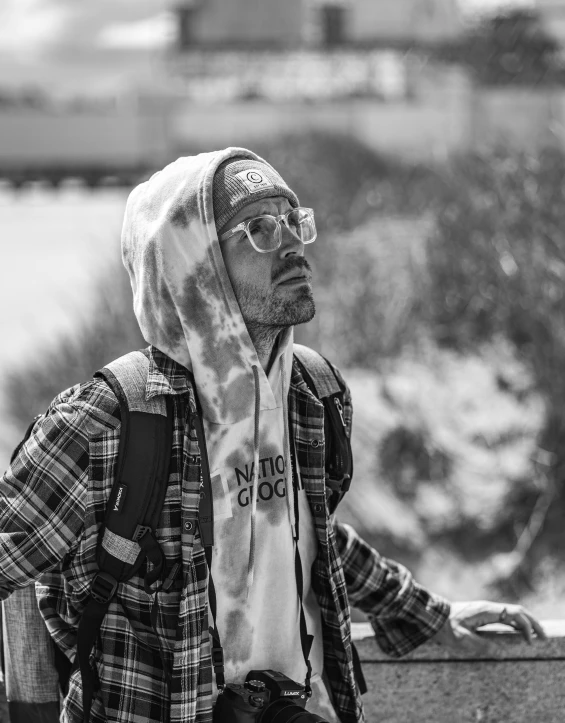 a man sitting on a park bench near some water