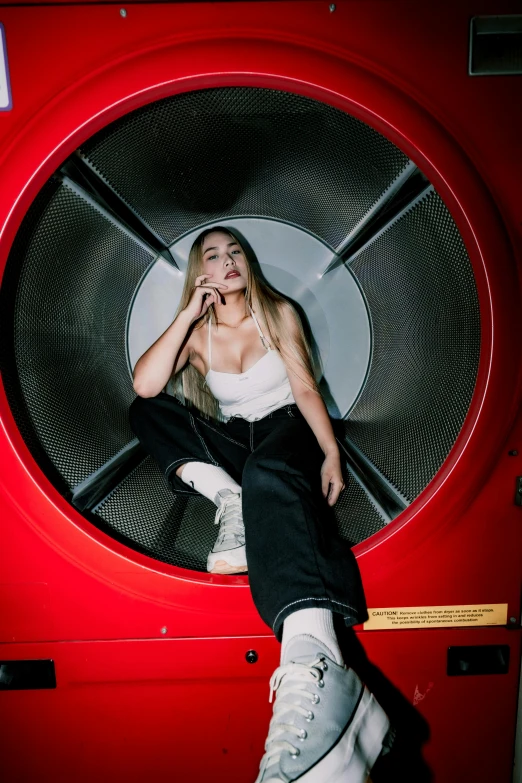 a woman sitting in a ventilator like room with a pair of white boots