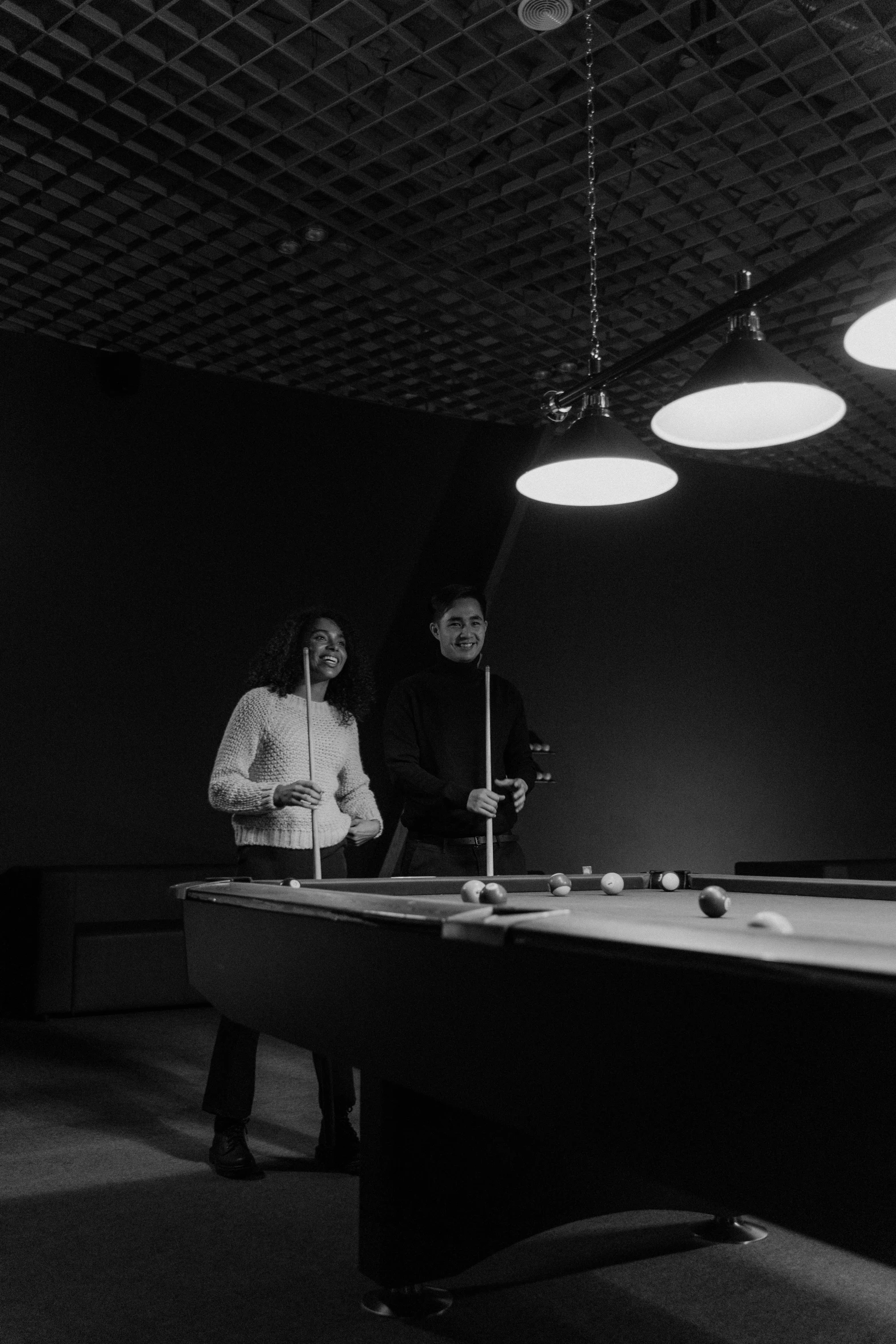 a pool table with people playing a game of pool