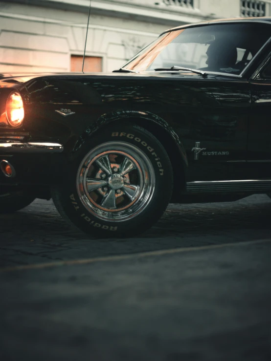 the rear end of a black car on the street