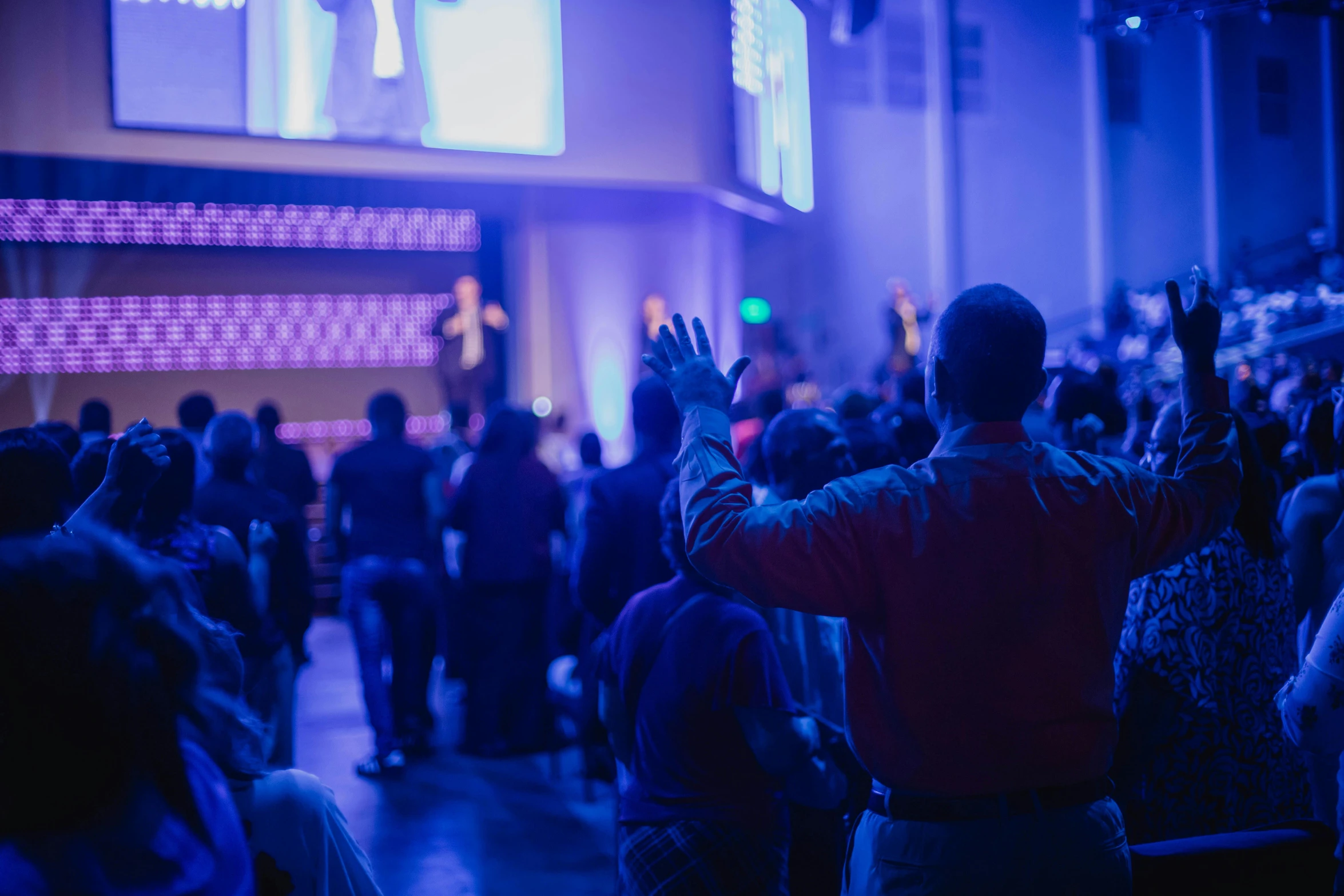 a man is raising his hands in the air