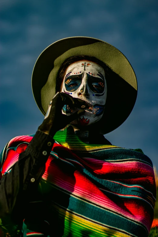 a person with skeleton makeup holding onto a hand