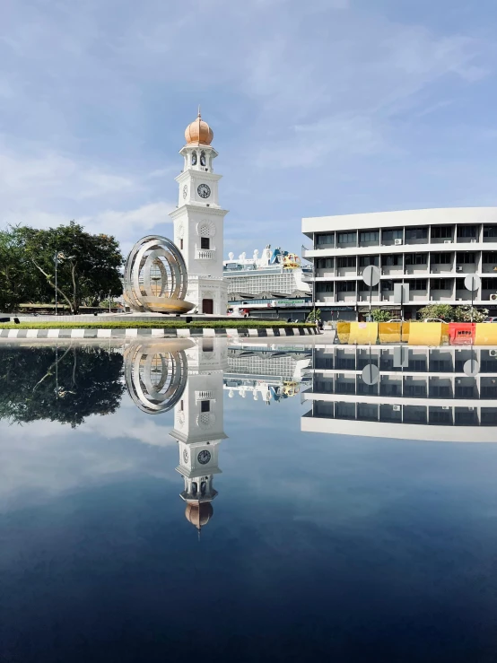 the large building is next to a water pond