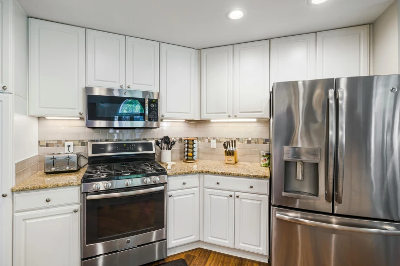 a large refrigerator sitting next to an oven and microwave