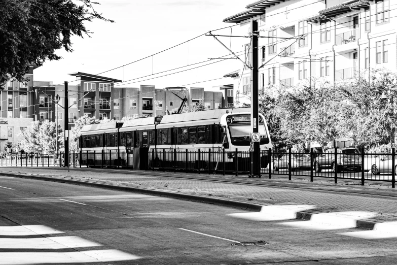 the train is traveling down the tracks by the building