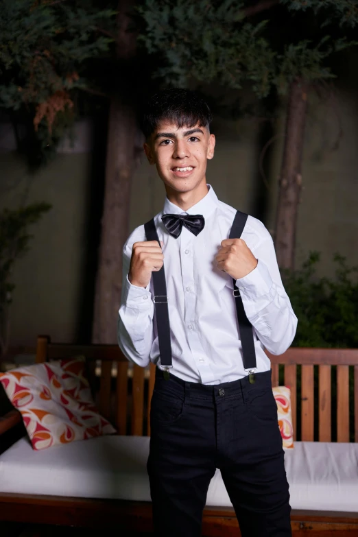 a young man in a white shirt and black pants