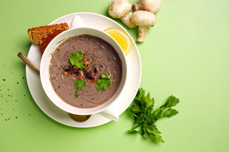 a bowl of soup with a spoon on the side