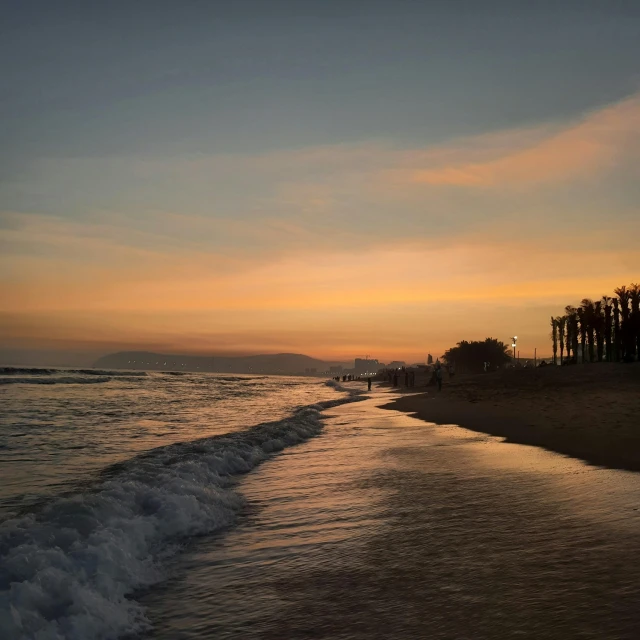 a view of a beach at sunset from a beachfront area