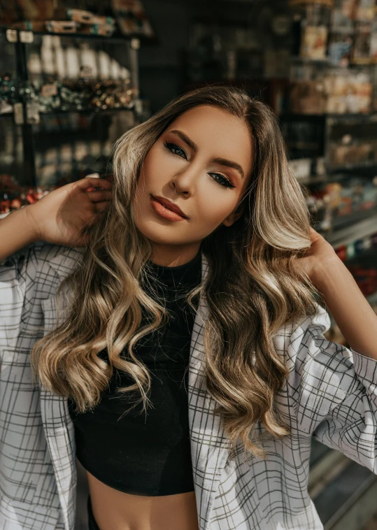 a woman wearing a black  and grey plaid shirt