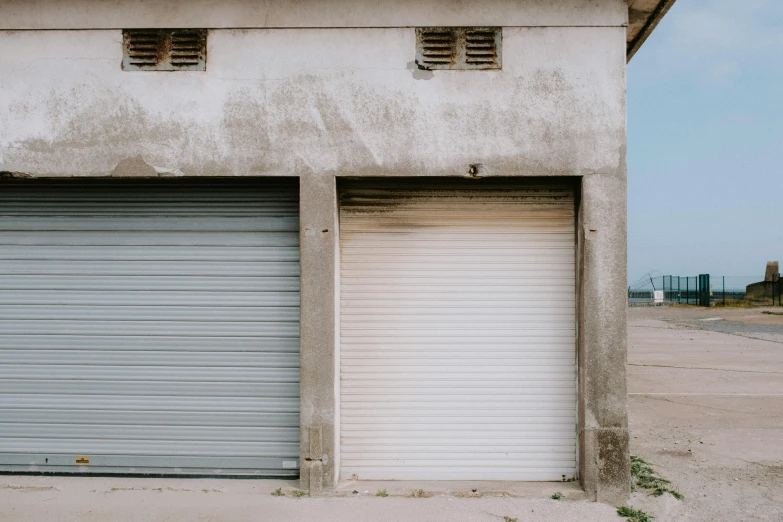 two open garages in an empty warehouse area