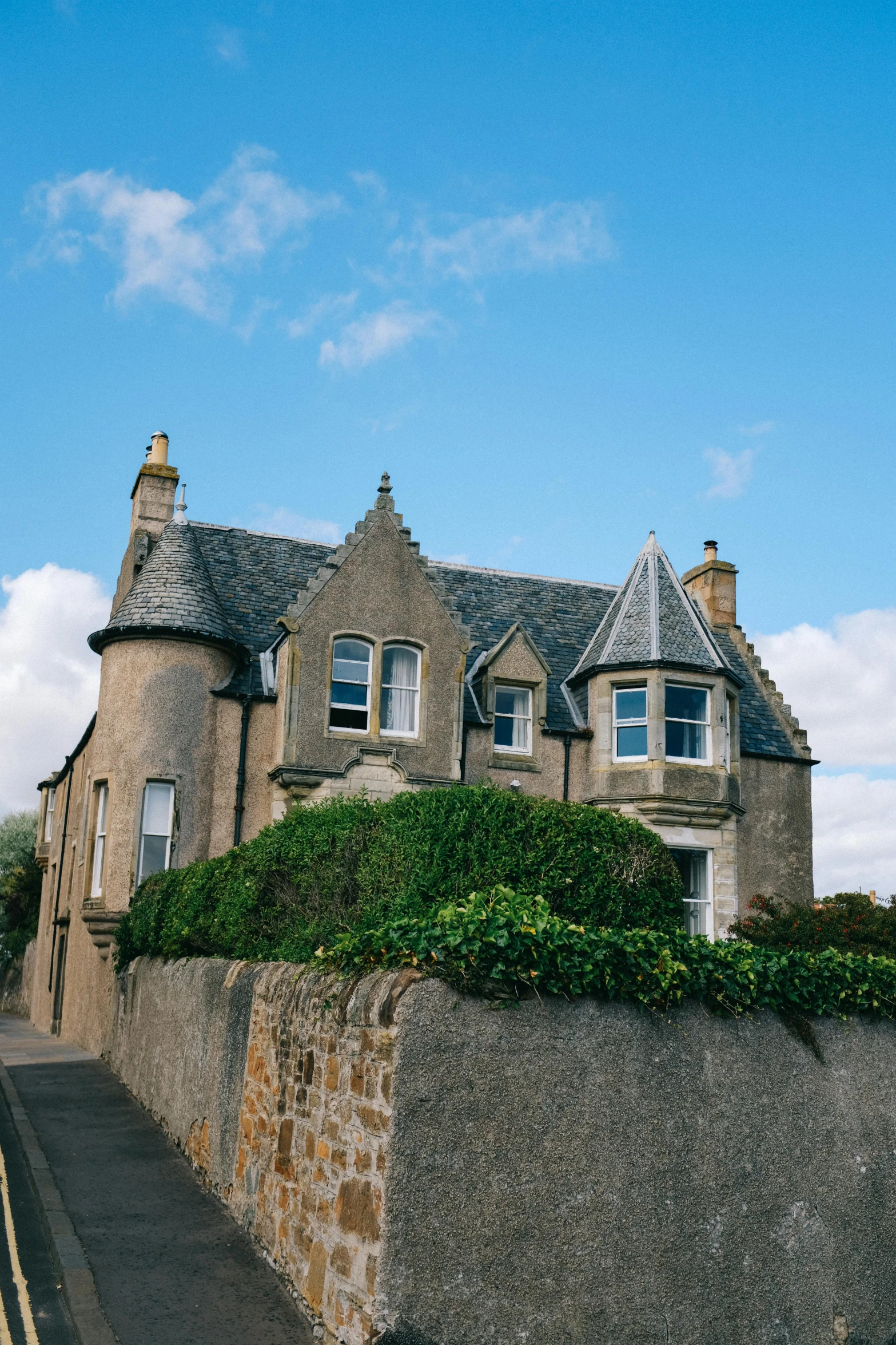 a tall stone building with many windows on it