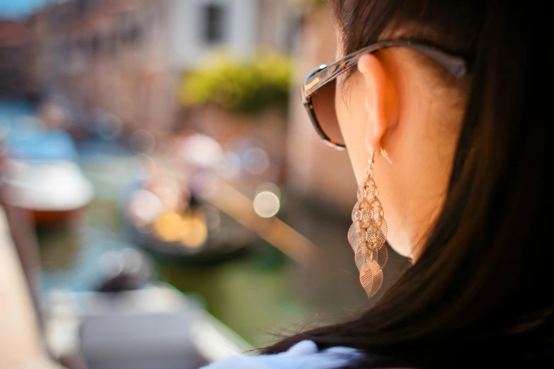 a woman wearing a pair of glasses and beaded earrings