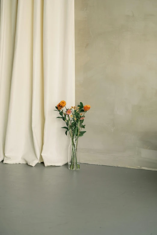 two small vases on a counter, with flowers in it