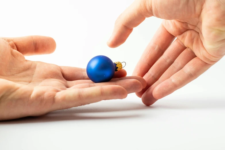 the person is holding an ornament in their hands