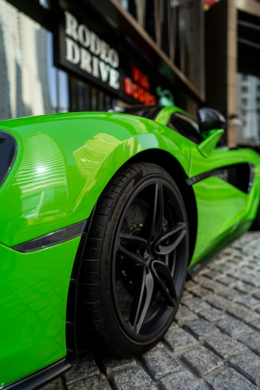 the bright green sports car is parked outside