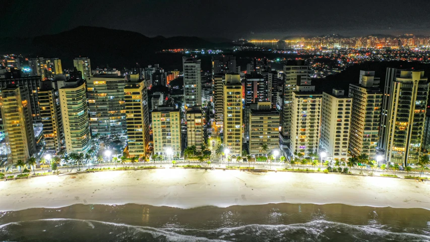 the aerial view of a city is lit up