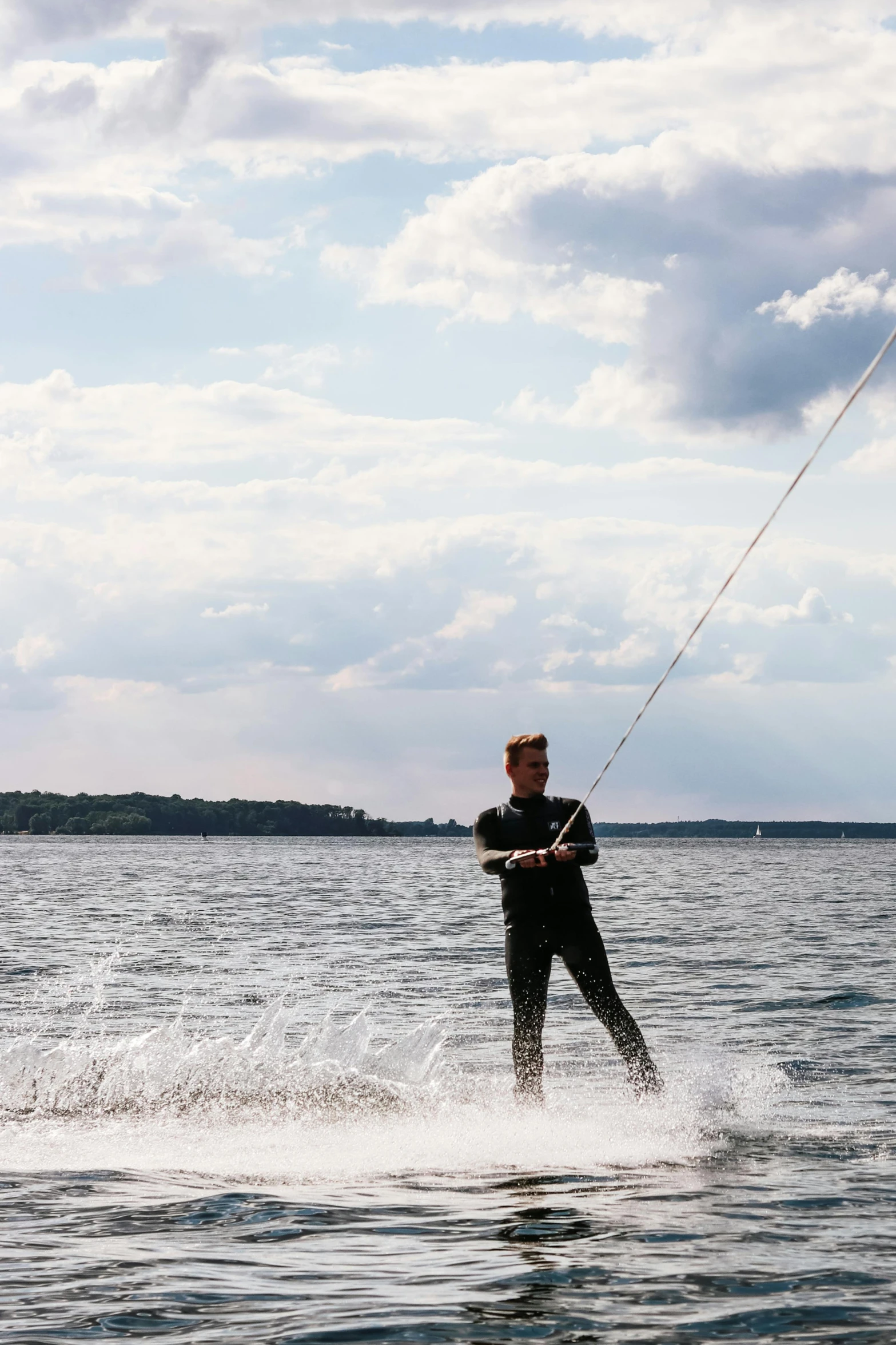 a person wearing a wet suit is water skiing in the ocean