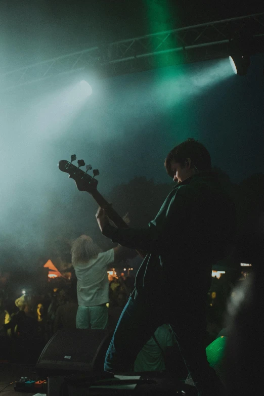 three guys playing music together on stage