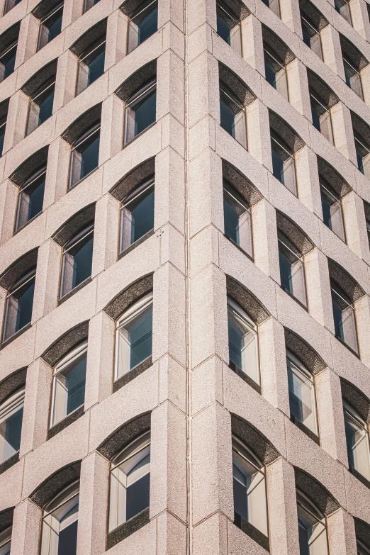 tall building with multiple windows near another building