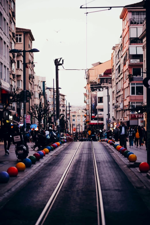 an empty city street filled with colorful balloons