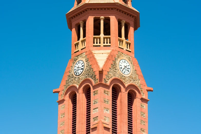 a clock tower with four clocks on each of it's sides