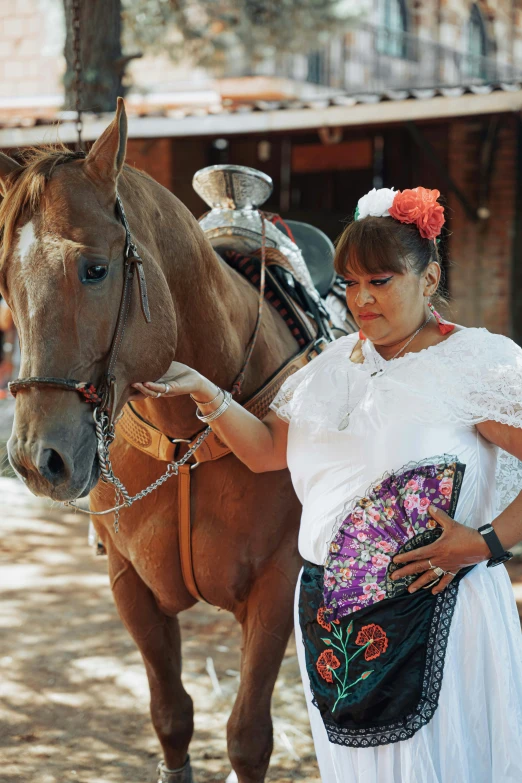 a woman holding the reins of a horse