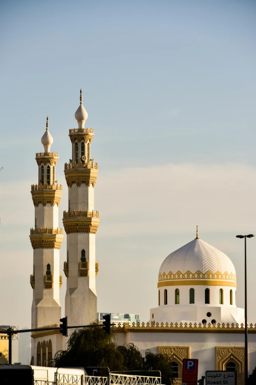 a tall building sitting behind two large white buildings