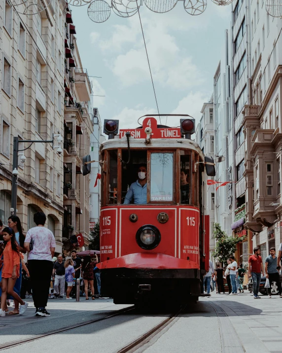 a red trolley car coming down the street