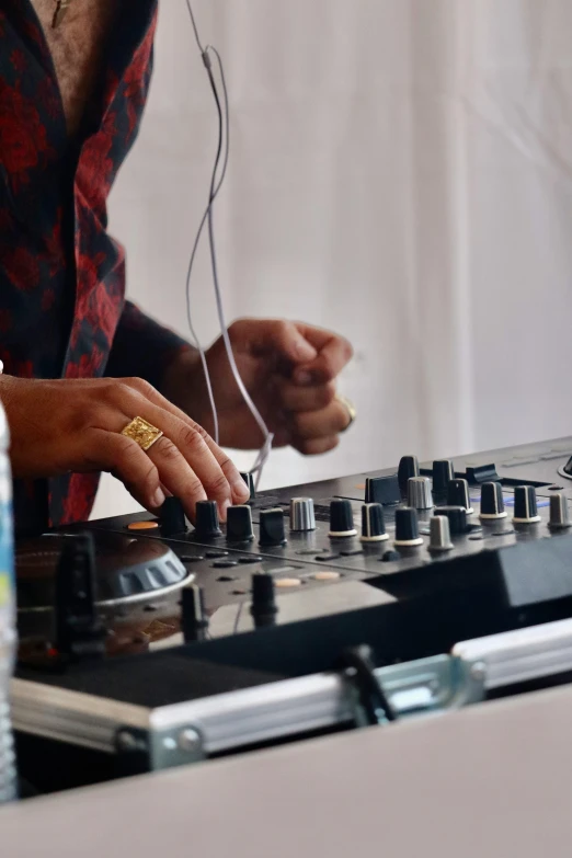 a person with headphones in front of the decks of a record player