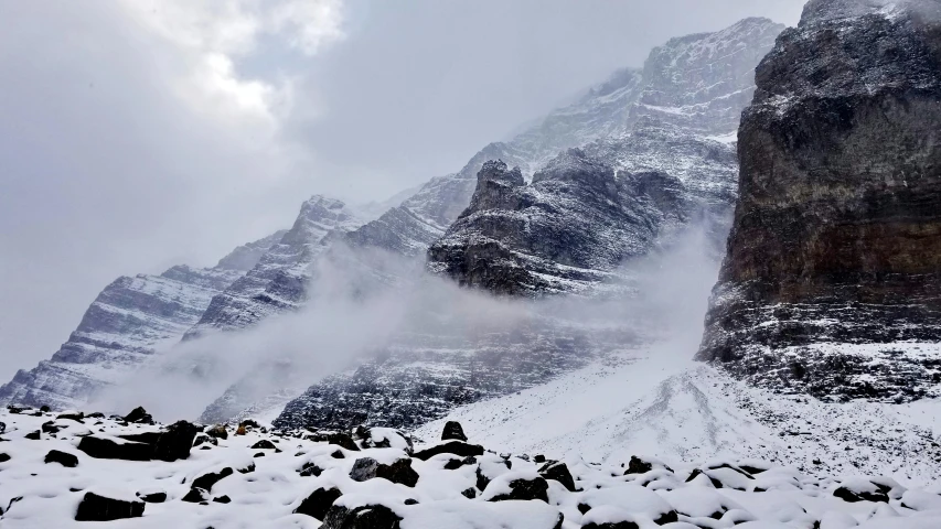 snow is covering the mountains, rocks and snow