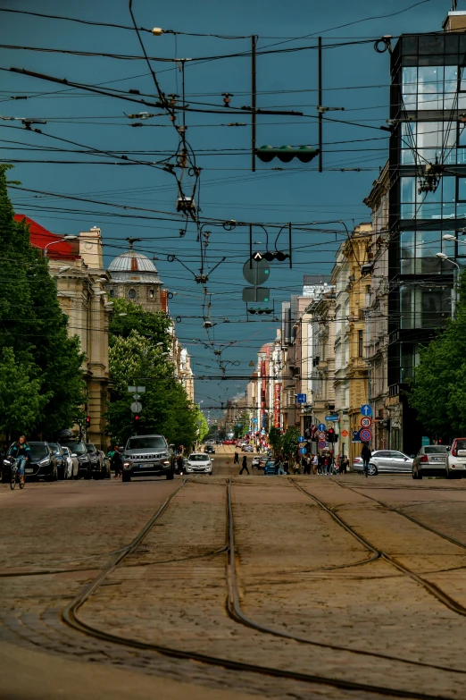 cars and people are on the street below a light pole