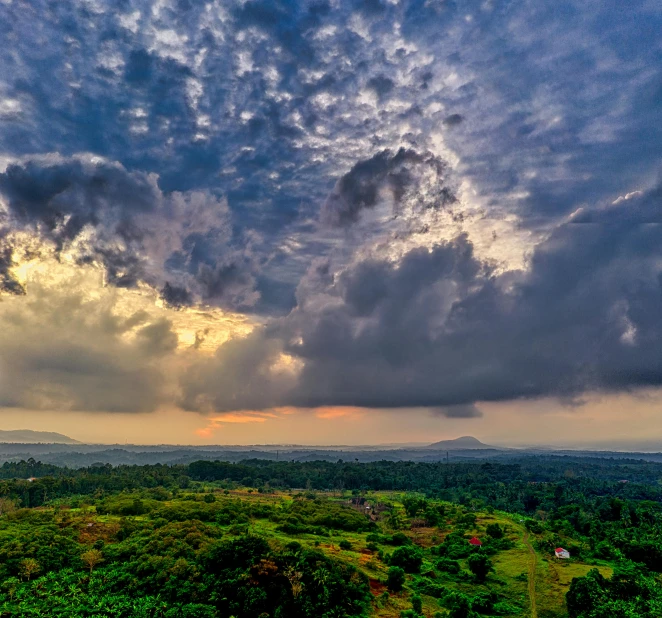 a bird - eye view of the sun going down over a large jungle