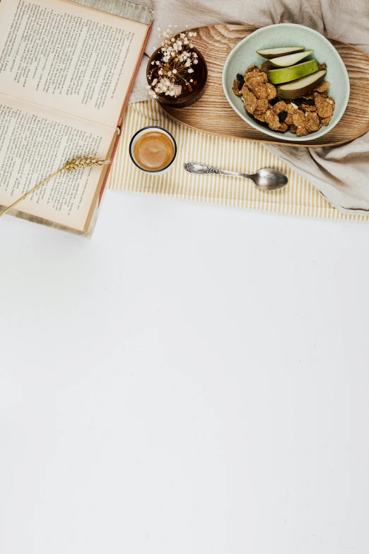 a close up of a plate of food near an open book