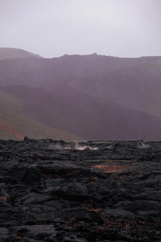 landscape in a rainy weather with a person standing on rocks