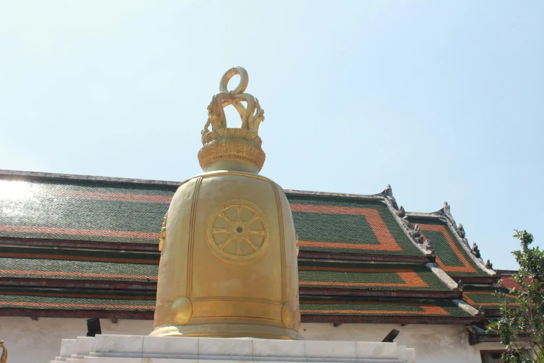 a large golden bell on top of a building