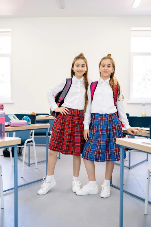 two s are posing in their school uniforms