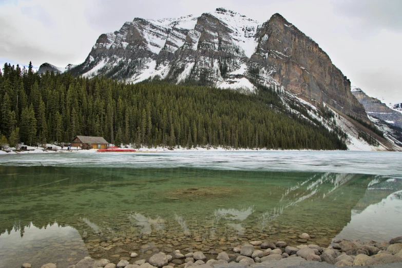 the mountains are covered in snow and evergreens