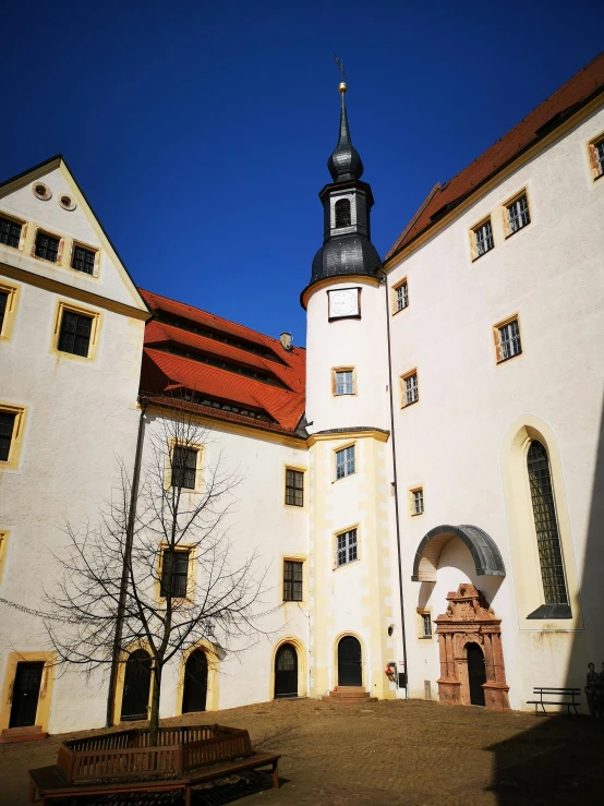 a building with a tall spire and clock tower