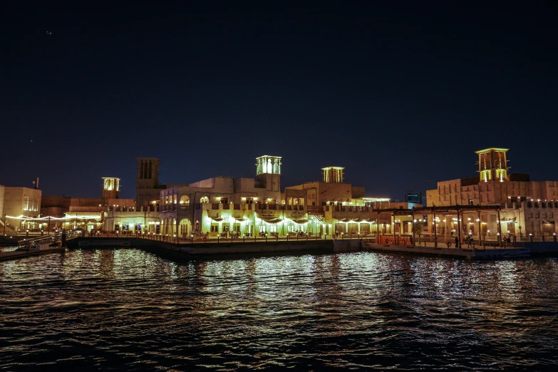 a night view of an urban town on a bay