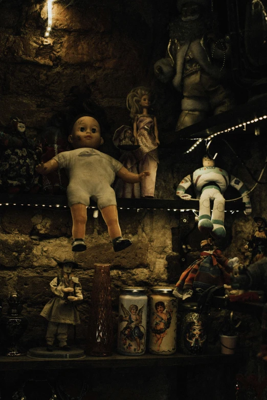 a collection of doll toys displayed in a shop window