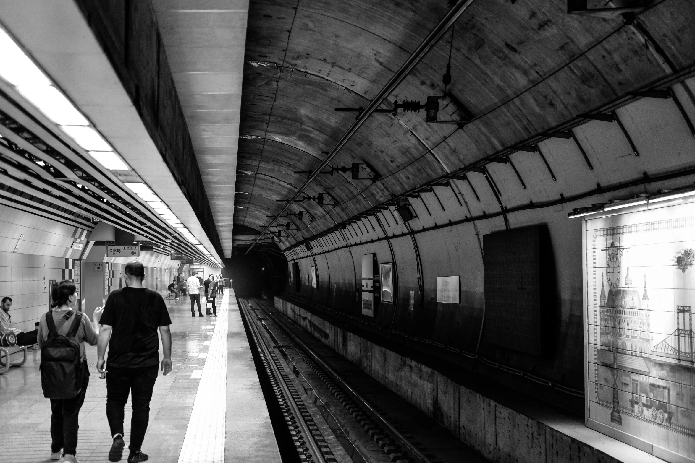 black and white po of people in a subway