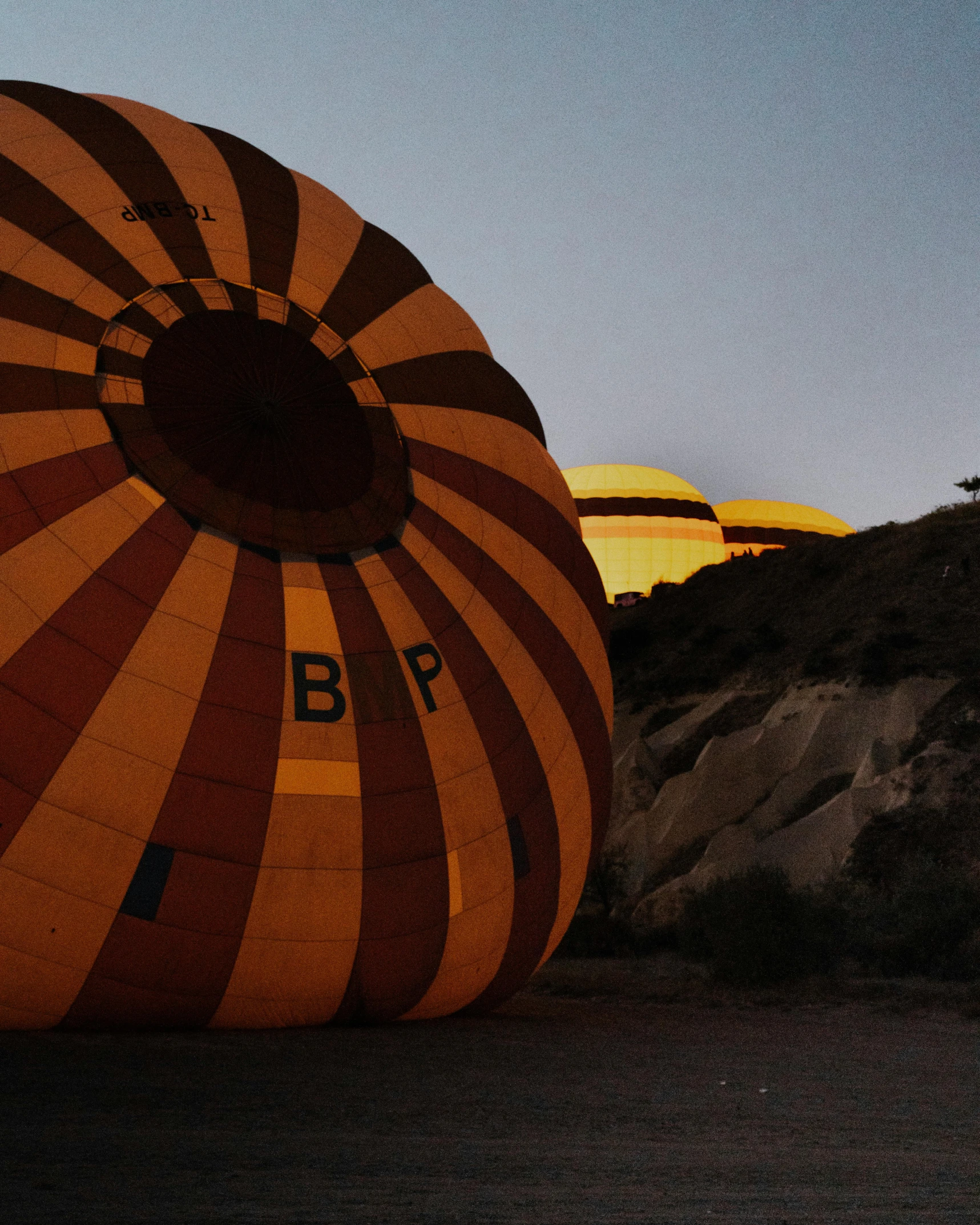 a large, orange and brown  air balloon with a number on it
