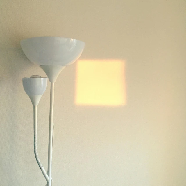 a wall lamp with shade from a window