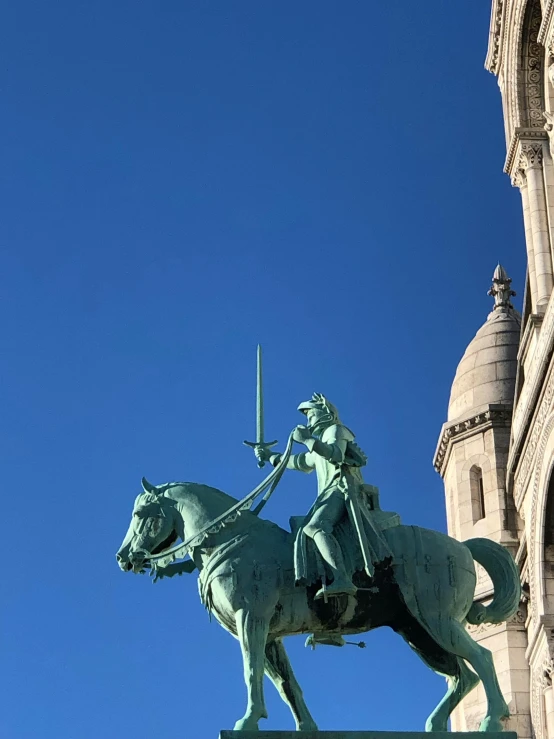 a statue on top of a horse with a sword on its rider