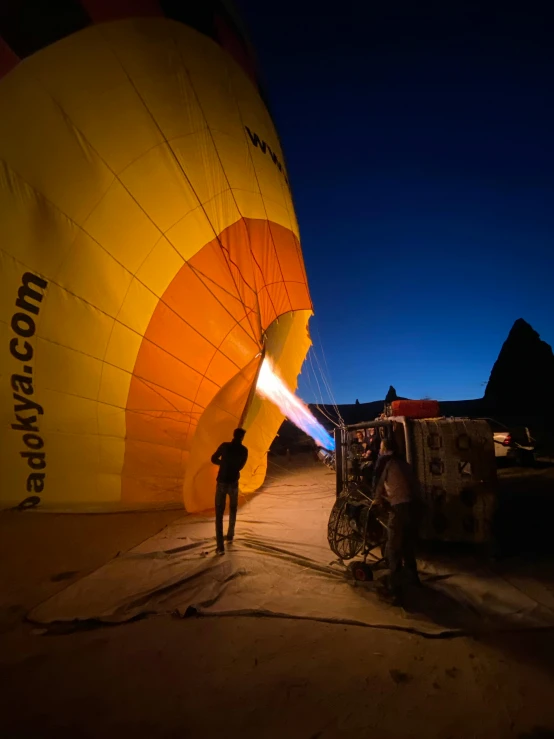 a man is standing next to a  air balloon