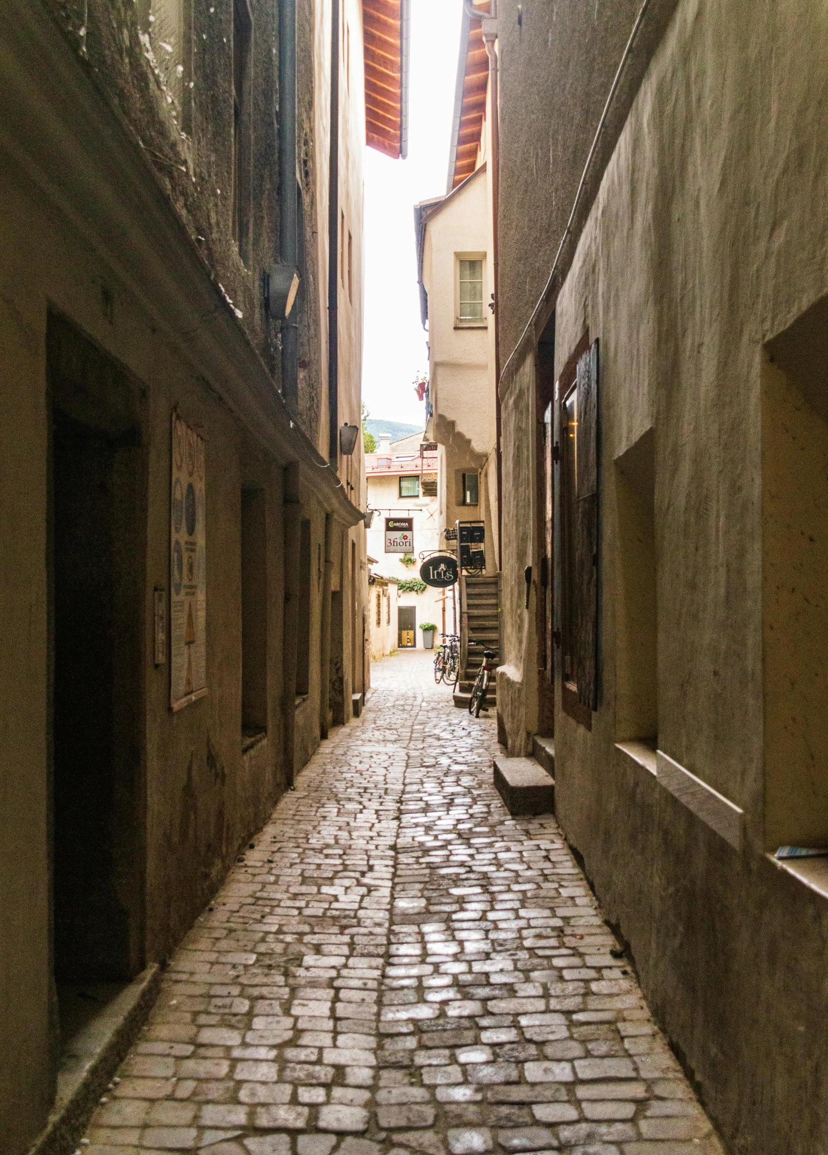 an empty street with many brick sidewalks and stairs