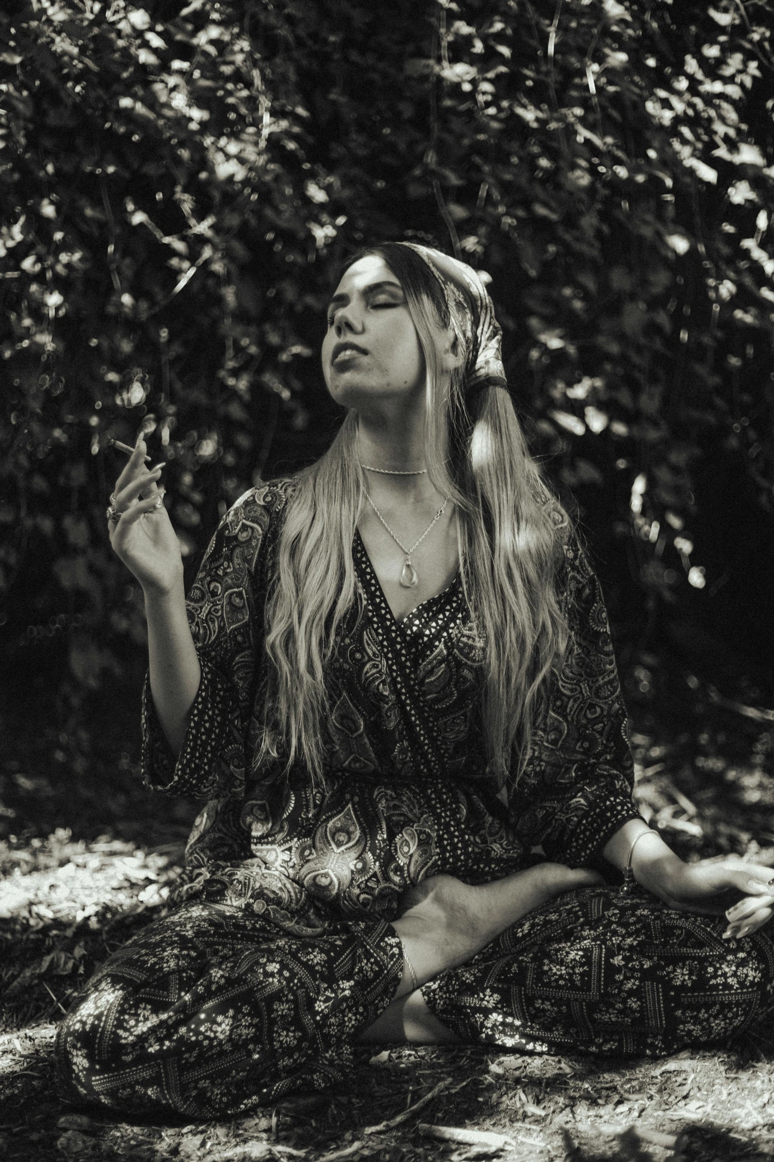 black and white po of a woman sitting on ground